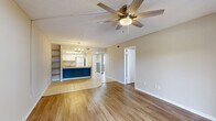 This upgraded 2-bedroom, 2-bathroom residence in Melbourne, FL offers a thoughtfully designed single-floor layout with contemporary finishes throughout. The living room is a bright, open space anchored by wood-look laminate flooring, a ceiling fan with light, and a sliding glass door that opens to a private balcony overlooking a pool area and lush greenery, allowing natural light to pour in.

The kitchen is a standout feature, boasting granite countertops with a peninsula-style breakfast bar, an undermount sink, white cabinetry, and stylish pendant lighting overhead — a clean, functional design ideal for everyday living and entertaining.

Both bedrooms are generously proportioned, each equipped with ceiling fans and windows that invite natural light. The primary bedroom offers comfortable space and connects to closet storage. Each bathroom is well-appointed: one features a tub/shower combo with granite-topped vanity and tile flooring, while the second includes a walk-in shower.

A dedicated laundry room with full-size washer and dryer adds everyday convenience. Two closets provide ample storage throughout. Consistent wood-look flooring flows across the main living areas, complemented by neutral tones that create a clean, welcoming ambiance throughout this move-in-ready Melbourne home.