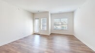 Located at 35 Mussey Rd in Scarborough, Maine, this single-floor residence offers a thoughtfully designed layout with modern finishes throughout. The open-concept living and kitchen area is anchored by warm wood-tone luxury vinyl plank flooring and crisp white walls, creating a bright and clean aesthetic. Large windows with blinds allow ample natural light to fill the living space, while a private entry door adds convenience and security.

The kitchen is a standout feature, outfitted with white shaker-style cabinetry extending to the ceiling, a white subway tile backsplash, light quartz countertops, and a central island ideal for dining or prep work. Stainless steel appliances — including a gas range, over-the-range microwave, dishwasher, and refrigerator — complete this well-equipped space.

The bedroom offers a comfortable and quiet retreat, finished with plush carpet, multiple windows for natural light, and easy access to the full bathroom and closet. The bathroom is cleanly appointed with classic black-and-white mosaic tile flooring, a walk-in shower, and a vanity. A stacked washer and dryer unit is conveniently integrated within the bathroom, adding practical in-unit laundry. A dedicated closet rounds out this efficiently planned home.