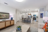 Located at 659 Treeland Dr in Ladson, South Carolina, this single-story residence offers a well-designed layout with modern finishes and a cohesive aesthetic throughout. The open-concept kitchen serves as a central hub, showcasing white cabinetry, granite countertops, stainless steel appliances — including a refrigerator with ice maker, electric range, and built-in microwave — along with a large kitchen island with pendant lighting and bar seating, ideal for casual dining and entertaining. Light wood-style flooring flows through the main living and kitchen areas, contributing to a bright, airy feel. The living area provides a comfortable retreat with natural light filtering through blinds and decorative drapery. Multiple bedrooms feature plush carpeting, ceiling fans, and windows that bring in natural light. Each bedroom offers generous proportions with ample space for furnishings. The bathrooms are appointed with granite vanity countertops, light wood cabinetry, large mirrors, and tile-style flooring, presenting a clean and polished look. The consistent use of neutral tones, recessed lighting, and quality finishes across all rooms creates a cohesive and inviting atmosphere throughout this well-appointed Ladson home.