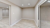 Located at 46 Avonwood Road in Avon, CT, this thoughtfully renovated 2-bedroom, 2-bathroom residence offers a clean, modern aesthetic across a well-organized single-floor layout. Light wood-look luxury vinyl flooring flows seamlessly throughout, complemented by neutral warm-beige walls and crisp white trim, creating a bright and cohesive atmosphere.

The living room is open and airy, illuminated by recessed lighting and connected to the rest of the home via a striking black-hardware sliding barn door with frosted glass panels — a standout design detail that adds both style and functionality. A long hallway with additional recessed lighting guides you through the space.

The kitchen is a visual highlight, featuring bold navy-blue lower cabinets paired with white upper cabinets, a herringbone tile backsplash, light stone countertops, and a full suite of stainless steel appliances including a gas range, dishwasher, and microwave.

The generously sized primary bedroom offers ample storage with dual sets of bifold closet doors, while the second bedroom includes a walk-in closet and a window providing natural light. Two full bathrooms complete the layout, with finishes consistent with the home's updated, contemporary style. The overall ambiance is clean, modern, and move-in ready.
