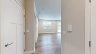 Located at 3325 Foundry Way in Wauwatosa, WI, this well-designed 2-bedroom, 2-bathroom unit offers a thoughtful single-floor layout with modern finishes throughout. The open-concept kitchen and living area serves as the heart of the home, featuring warm hardwood-style flooring, a central island with a granite-style countertop and pendant lighting above, dark wood cabinetry, and a full suite of stainless steel appliances. Recessed lighting and multiple windows allow natural light to fill the living space, which offers views of the surrounding greenery.

Both bedrooms are comfortably sized, with the primary bedroom offering plush carpeting, a wall-mounted mini-split HVAC unit, and a window with outdoor views. The second bedroom features hardwood-style flooring, recessed lighting, and its own mini-split unit for personalized climate control.

The two bathrooms are finished with granite-style countertops, dark wood vanity cabinetry with brushed nickel hardware, large framed mirrors, and wood-look tile flooring. One bathroom includes a walk-in shower with grab bars, while the other features a tub-shower combo. A dedicated closet provides additional storage. The unit's clean, neutral color palette and modern fixtures create a cohesive, contemporary ambiance throughout.