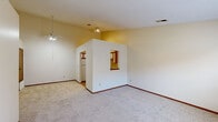 Located at 1530 Russell Dr in Streetsboro, Ohio, this single-floor home offers a practical and well-organized layout with two bedrooms and three bathrooms. The open living area features soft carpeting, neutral warm-toned walls, and a ceiling fan, creating a comfortable and inviting atmosphere. A pass-through window connects the living space to the kitchen, enhancing the sense of openness between rooms.

The kitchen is efficiently designed with an L-shaped layout, featuring white cabinetry accented by warm wood trim, ample upper and lower storage, white countertops, a stainless steel double-basin sink, and a dishwasher. The flooring transitions to tile in this area, adding a practical touch. A full-size refrigerator completes the kitchen's appliance lineup.

The primary bedroom is generously sized, offering carpeted flooring and a window that brings in natural light with views of the surrounding neighborhood. The second bedroom also features carpet and includes a sliding closet with built-in rod storage. Both rooms benefit from textured ceilings and warm neutral tones throughout.

The bathrooms include a full tub-and-shower combination with decorative surround paneling. A dedicated laundry closet provides washer and dryer hookups, adding everyday convenience. The hallway connects all spaces efficiently, rounding out this well-appointed home.