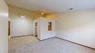 Located at 1530 Russell Dr in Streetsboro, Ohio, this single-floor home offers a practical and well-organized layout with two bedrooms and three bathrooms. The open living area features soft carpeting, neutral warm-toned walls, and a ceiling fan, creating a comfortable and inviting atmosphere. A pass-through window connects the living space to the kitchen, enhancing the sense of openness between rooms.

The kitchen is efficiently designed with an L-shaped layout, featuring white cabinetry accented by warm wood trim, ample upper and lower storage, white countertops, a stainless steel double-basin sink, and a dishwasher. The flooring transitions to tile in this area, adding a practical touch. A full-size refrigerator completes the kitchen's appliance lineup.

The primary bedroom is generously sized, offering carpeted flooring and a window that brings in natural light with views of the surrounding neighborhood. The second bedroom also features carpet and includes a sliding closet with built-in rod storage. Both rooms benefit from textured ceilings and warm neutral tones throughout.

The bathrooms include a full tub-and-shower combination with decorative surround paneling. A dedicated laundry closet provides washer and dryer hookups, adding everyday convenience. The hallway connects all spaces efficiently, rounding out this well-appointed home.