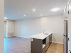 Located at 1100 Afton Dr in Windsor, Ontario, this well-appointed one-bedroom, one-bathroom unit offers a thoughtfully designed layout across a single floor. The open-concept kitchen and living area serves as the heart of the space, featuring a striking blue kitchen island with a white quartz countertop, white shaker-style cabinetry, stainless steel appliances including a refrigerator and electric range, and recessed lighting overhead. Warm, light-toned hardwood-style flooring flows consistently throughout every room, creating a cohesive and inviting atmosphere. The living area is bright and airy, with a sliding glass door that opens to a balcony, allowing natural light to fill the space and providing views of the surrounding neighbourhood. The bedroom is a comfortable, well-proportioned room featuring a large window that brings in additional natural light and outdoor views, along with a sliding closet door for practical storage. The bathroom is finished in a clean, modern style with white shaker vanity cabinetry, a white quartz countertop, a full bathtub and shower combo, and consistent hardwood-style flooring. Neutral, warm-toned walls throughout the unit contribute to a calm and contemporary ambiance, making this a functional and stylish space.