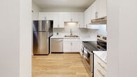 Located at 14625 Portland Ave in Burnsville, Minnesota, this single-floor unit offers a clean, modern living environment with thoughtfully updated interiors throughout. Luxury vinyl plank flooring runs consistently across the living areas and bedrooms, providing a cohesive and low-maintenance aesthetic.

The kitchen stands out as a highlight of the space, featuring crisp white shaker-style cabinetry, marble-look countertops, and a full suite of stainless steel appliances including a refrigerator, dishwasher, and electric range with overhead ventilation. The layout is efficient and well-organized, offering ample cabinet and counter space for everyday use.

The living area is generously sized and bathed in natural light, with a sliding glass door that opens onto a private balcony — ideal for enjoying outdoor views. A ceiling fan adds comfort and functionality to the room, while baseboard heating ensures warmth throughout the colder Minnesota months. A wall-mounted air conditioning unit also provides climate control in the warmer seasons.

The bedroom is a comfortable, well-proportioned room with a large window that brings in natural light and views of the surrounding neighborhood. The bathroom is neatly appointed with a full tub-and-shower combination, coordinating brushed nickel fixtures, a single vanity, and wood-look flooring that ties the space together. Overall, the unit presents a well-maintained, move-in ready living space with practical modern upgrades.