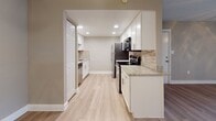 Located at 10912 N 53rd St in Temple Terrace, Florida, this single-floor unit offers a well-organized layout with consistent finishes throughout. The living area is generously proportioned, featuring wood-look flooring, neutral-toned walls, and a ceiling fan with light fixture. A full-length sliding glass door floods the space with natural light and provides outdoor access. The kitchen is a functional highlight, showcasing white cabinetry, granite countertops, a stone tile backsplash, recessed lighting, and a full suite of stainless steel appliances, including a refrigerator, electric range, microwave, and dishwasher. It connects seamlessly to the main living space, creating an open feel. The bedrooms each feature wood-look flooring, ceiling fans, and windows that allow natural light. One bedroom includes a pendant light fixture and louvered closet doors. The bathrooms are well-appointed, with one featuring a tiled tub-shower combination and granite-topped vanity, and a second offering a white vanity with granite countertop. Throughout, clean white baseboards and neutral wall tones create a cohesive, move-in-ready atmosphere.
