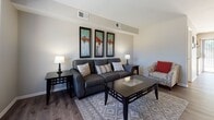 Located in the established Creve Coeur neighborhood of St. Louis County, this two-story home offers a thoughtfully designed layout with a blend of classic character and modern finishes. The main level showcases a spacious living room with durable hardwood-style flooring, neutral walls, and vaulted-style ceilings that lend an open, airy feel. The room flows naturally toward a staircase with a classic newel post, connecting both levels of the home. The adjacent dining area is a standout space, featuring a striking exposed brick accent wall that adds warmth and texture, along with a ceiling fan and a large sliding glass door that floods the room with natural light and provides outdoor access. The kitchen is well-equipped with white cabinetry, stone-look countertops, stainless steel appliances including a refrigerator and dishwasher, and hardwood-style flooring that ties the main level together cohesively. Upstairs, the bedrooms offer plush carpeting, generous natural light through large windows with sheer curtains, and ceiling fans for comfort. The bathroom is neatly finished with a tiled tub-shower combination, wood-style flooring, and clean white fixtures. Throughout the home, the design balances comfort and practicality in a welcoming, move-in-ready environment.