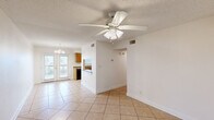 This single-story, 2-bedroom, 2-bathroom home in Slidell, Louisiana offers a functional and comfortable layout designed for everyday living. The open living and dining area is finished with light tile flooring and features ceiling fans with integrated lighting, a textured ceiling, and French doors that invite natural light while providing access to the outdoor deck. A chandelier accent adds a touch of warmth to the dining space.

The kitchen is equipped with warm wood cabinetry, granite-style countertops, a double-basin sink, and black appliances including a gas range, dishwasher, and refrigerator. A pass-through window connects the kitchen to the living area, enhancing the open feel. Additional pantry or storage space is accessible directly from the kitchen.

Both bedrooms are carpeted and feature ceiling fans with lighting, windows with blinds, and closets with wire shelving. The layout provides a comfortable and private retreat in each room. The two bathrooms are finished with tile flooring, wood vanities, and white countertops, and each includes a bathtub and shower combination.

A dedicated laundry area with wire shelving adds practical in-unit convenience. The home also includes an outdoor deck, rounding out this well-appointed residence in the Slidell community.