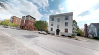 Situated at 1030 N. College Avenue in Indianapolis, Indiana, this space is housed within a stately, multi-story building featuring a striking white painted exterior with decorative cornice detailing and large, symmetrically arranged windows that lend the structure a timeless, classic character. The building's bold street-facing façade is accented by a formal arched entryway, adding a distinguished and professional aesthetic to the property.

The single-floor layout offers a cohesive and accessible environment, well-suited for a variety of uses. The building's generous window placement allows for ample natural light to filter into the interior, creating a bright and welcoming atmosphere throughout. The structure's architectural detailing reflects a traditional design sensibility, combining sturdy construction with refined exterior finishes.

Positioned along a well-traveled corridor in Indianapolis, the property benefits from strong street visibility and convenient access. The surrounding neighborhood features a mix of modern and historic architecture, reflecting the dynamic character of this urban setting. Mature trees line the area, providing a touch of greenery that softens the urban streetscape. This location places occupants within easy reach of the broader Indianapolis metro area, making it a practical and prominently situated destination.