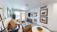 Located in Katy, TX, this single-story, one-bedroom, one-bathroom residence offers a thoughtfully designed open-concept layout. The combined kitchen and living area forms the heart of the home, where wood-look flooring flows seamlessly throughout. The kitchen is a standout, featuring crisp white cabinetry, a white subway tile backsplash, granite countertops, stainless steel appliances, and a large island with a built-in sink and pendant lighting overhead — ideal for both cooking and casual dining. The living room is bright and inviting, with multiple windows that invite natural light and provide outdoor views, complemented by neutral walls and ample space for comfortable seating. The bedroom is a serene retreat, highlighted by a distinctive sage green accent wall, a ceiling fan, and large windows that bring in additional natural light. The bathroom is clean and functional, offering a granite-topped vanity with white cabinetry, a large mirror, and a tub-shower combination with elegant tile surround. Consistent, modern finishes and a cohesive design aesthetic tie every room together, making this a comfortable and stylish residence in the Houston metro area.