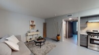 Located at 746 S Westlake Ave in the Westlake neighborhood of Los Angeles, this single-floor unit offers a thoughtfully laid-out living space with a contemporary design aesthetic throughout. The living area is finished with smooth concrete-style flooring and soft gray walls, creating a clean, modern backdrop. Natural light filters in through vertical blinds, complementing the open feel of the room. Decorative touches, including wall art and eclectic accents, add warmth and character to the space.

The kitchen is efficiently designed with sleek gray cabinetry, a stainless steel gas range, a built-in dishwasher, and a modern sink with ample counter space. Overhead lighting brightens the workspace, while an open shelving unit adds a contemporary finishing touch. A glass dining table positioned nearby makes for a seamless transition between cooking and dining.

The bedroom is a bright, quiet room featuring multiple windows fitted with horizontal and vertical blinds, allowing for flexible light control. The smooth flooring continues throughout, maintaining a cohesive look across the unit.

The bathroom is clean and functional, featuring a full soaking tub with shower combination set against white tiled walls, with a small window near the ceiling providing natural ventilation and light. Overall, the unit presents a minimalist yet inviting atmosphere well-suited to comfortable urban living in Los Angeles.