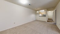 Located at 1101 Cobblestone Circle in Kissimmee, Florida, this single-floor, 2-bedroom, 2-bathroom home offers a practical and comfortable layout. The open-concept living, dining, and kitchen area forms the heart of the home, with plush carpeting underfoot and a textured ceiling overhead. The kitchen features light wood cabinetry, a white appliance suite, and a pass-through counter with a pendant light above, creating a natural connection to the dining and living spaces.

Both bedrooms are carpeted and well-lit by windows that allow natural light to filter in, offering views of the surrounding greenery. The primary bedroom provides a generous amount of space and includes a closet with louvered bifold doors. The second bedroom also features its own closet and direct access to the hallway.

The two full bathrooms are finished with wood-look tile flooring, light wood vanity cabinetry, and full tub-shower combinations with white tile surrounds. A dedicated utility room adds functional storage and convenience.

A central hallway with wood-look flooring connects the rooms, and a prominent HVAC vent panel is conveniently accessible. Throughout, neutral tones and a clean, understated aesthetic create a bright, move-in-ready atmosphere.