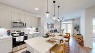 Located at 2001 E Fourth St in Fort Worth, TX, this one-bedroom, one-bathroom residence delivers a thoughtfully designed open-concept floor plan that maximizes every square foot. Light hardwood flooring flows throughout, anchoring a bright and cohesive aesthetic defined by white walls and clean contemporary finishes.

The kitchen is a standout feature, boasting white shaker cabinetry with matte black hardware, quartz countertops, a subway tile backsplash, and a full suite of stainless steel appliances. A generous island with pendant lighting serves as both a functional workspace and a casual dining area, connecting seamlessly to the living and dining spaces.

The living room is bathed in natural light through large French doors that offer outdoor views, complemented by a ceiling fan and warm, neutral tones that create an inviting atmosphere. The entry hallway is clean and minimal, with wood flooring continuing from the main living areas.

The bedroom features a window with ample natural light, a ceiling fan, and a calm, restful ambiance. The bathroom is well-appointed with a dual-sink vanity, grey cabinetry, framed mirrors, white quartz countertops, large-format tile flooring, and a tub-shower combination with tile surround. Together, these spaces form a cohesive, modern home in the heart of Fort Worth.