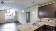 Located at 500 S Lasalle St in Durham, NC, this well-appointed 2-bedroom, 4-bathroom residence offers a thoughtfully designed single-level layout. The open-concept kitchen is a standout feature, showcasing rich dark cabinetry, granite countertops with a subway tile backsplash, a peninsula island with a double sink, pendant lighting, and black appliances including a range, microwave, and refrigerator. Crown molding and track lighting add refined detail throughout. The living area features a tray ceiling with crown molding, an arched window that invites abundant natural light, dark hardwood-style flooring, and a glass-panel door providing outdoor access. Both bedrooms are carpeted and equipped with ceiling fans. The primary bedroom includes an en-suite bathroom and access to a closet, while the second bedroom benefits from a large arched window with outdoor views. The four bathrooms are finished with granite-topped dark vanities, tile flooring, and tub-shower combinations featuring classic white subway tile surrounds. Three generously sized closets and a dedicated utility room round out this functional and stylish residence, making it an ideal home in the heart of Durham.
