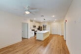 Located at 352 S Foster Dr in Baton Rouge, Louisiana, this well-appointed 2-bedroom, 2-bathroom single-floor residence offers a thoughtfully designed open-concept layout that maximizes both functionality and comfort. Warm hardwood-style flooring flows seamlessly throughout the entire space, creating a cohesive and inviting atmosphere.

The kitchen serves as the heart of the home, anchored by a large center island with a white quartz countertop, undermount sink, and sleek matte black fixtures. Crisp white shaker-style cabinetry lines the walls, complemented by stainless steel appliances including a range, built-in microwave, and refrigerator. A dedicated pantry provides generous additional storage. Stylish linear pendant lighting hangs above the island, adding a contemporary touch. The kitchen opens directly into the living area, which benefits from natural light through multiple windows with blinds and is finished with a ceiling fan overhead.

The spacious primary bedroom offers ample room and connects to a private bathroom featuring a white vanity with quartz countertops, matte black hardware, and a tiled tub-shower combo. The second bedroom is well-sized with a large window and ceiling fan. The second bathroom mirrors the same clean, modern finishes. Ceiling fans are present throughout, enhancing year-round comfort in this stylish Baton Rouge residence.