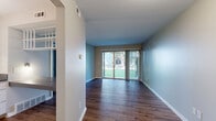 Located at 412 Thurber Dr W in Columbus, Ohio, this one-bedroom, one-bathroom unit offers a practical and well-organized single-floor layout. Wood-style plank flooring runs throughout the entire space, providing a cohesive and warm aesthetic from room to room.

The combined kitchen and living area forms the heart of the unit. The living room benefits from a full-width sliding glass door that opens to a grassy outdoor area, filling the space with generous natural light. The kitchen is efficiently designed in an L-shaped configuration, featuring white cabinetry with ample upper and lower storage, gray laminate countertops, a white electric range with overhead ventilation, and a full-size refrigerator. Open shelving adds additional display and storage options.

A hallway connects the main living area to the private quarters, leading to the bedroom, which offers a comfortable footprint with a window that allows natural light in. Neutral wall tones and dark wood-style flooring give the room a calm, restful character.

The full bathroom is well-appointed, featuring a tub and shower combination with a striking marble-style surround, a vanity with gray countertop and white cabinetry, and wood-style flooring that ties in with the rest of the unit. The overall design is clean, neutral, and move-in ready.