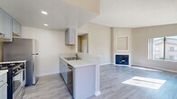 Located at 2130 S Santa Fe Ave in Vista, CA, this single-story, 3-bedroom, 2-bathroom home offers a well-designed layout that maximizes every inch of its compact footprint. Light wood-style flooring runs throughout, complementing the warm neutral tones on the walls and creating a cohesive, modern aesthetic.

The open-concept living area is anchored by a corner fireplace with a white surround and built-in display niche above, adding a focal point to the space. Large windows flood the room with natural light and offer views of the surrounding neighborhood and hillside. The living area flows directly into the kitchen, which features gray shaker-style cabinetry, white countertops, stainless steel appliances including a gas range and dishwasher, and a peninsula with a sink — ideal for both cooking and casual dining.

The three bedrooms are bright and well-proportioned, each with wood-style flooring, neutral walls, and windows that bring in ample natural light. The primary bedroom provides a comfortable and private retreat. Two closets serve the home's storage needs. The two bathrooms are clean and functional, each equipped with a tub-shower combo, vanity with a white countertop, and updated fixtures. A hallway connects the bedrooms and bathrooms, keeping the layout organized and efficient.