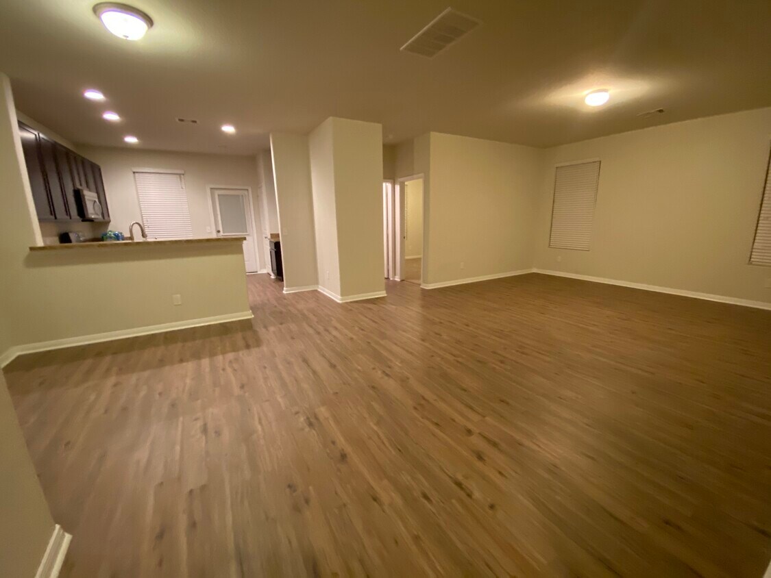 View of living room and downstairs bedroom as you walk in - 819 Salado Slough Ln