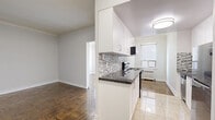 Located at 787 Vaughan Rd in Toronto's Oakwood Village, this 1-bedroom plus den unit offers a well-organized layout across a single floor. Warm parquet flooring flows throughout the living spaces, lending a classic character to the home.

The updated kitchen is a standout feature, outfitted with crisp white cabinetry, dark granite-style countertops, a mosaic tile backsplash, and stainless steel appliances including an electric range with microwave and a dishwasher. Light tile flooring grounds the galley-style layout, which includes a window and radiator for natural light and heating.

The living room is an open, airy space that connects seamlessly to the kitchen via a half-wall peninsula. Crown moulding adds a refined architectural touch. The bedroom is generously sized, featuring parquet flooring, a large sliding-door closet, and clean neutral walls. The den provides flexible additional space suitable as a home office or secondary sleeping area, complete with a bright window and radiator. Two closets offer ample storage throughout the unit.

The bathroom is finished in crisp white tile with a clean, modern vanity and mirror. The unit also features a second closet for additional storage. Radiator heating is present throughout, ensuring comfort year-round.