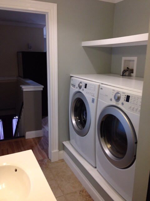 Storage shelf and folding table above washer/dryer in the bathroom - 282 Brackett Street