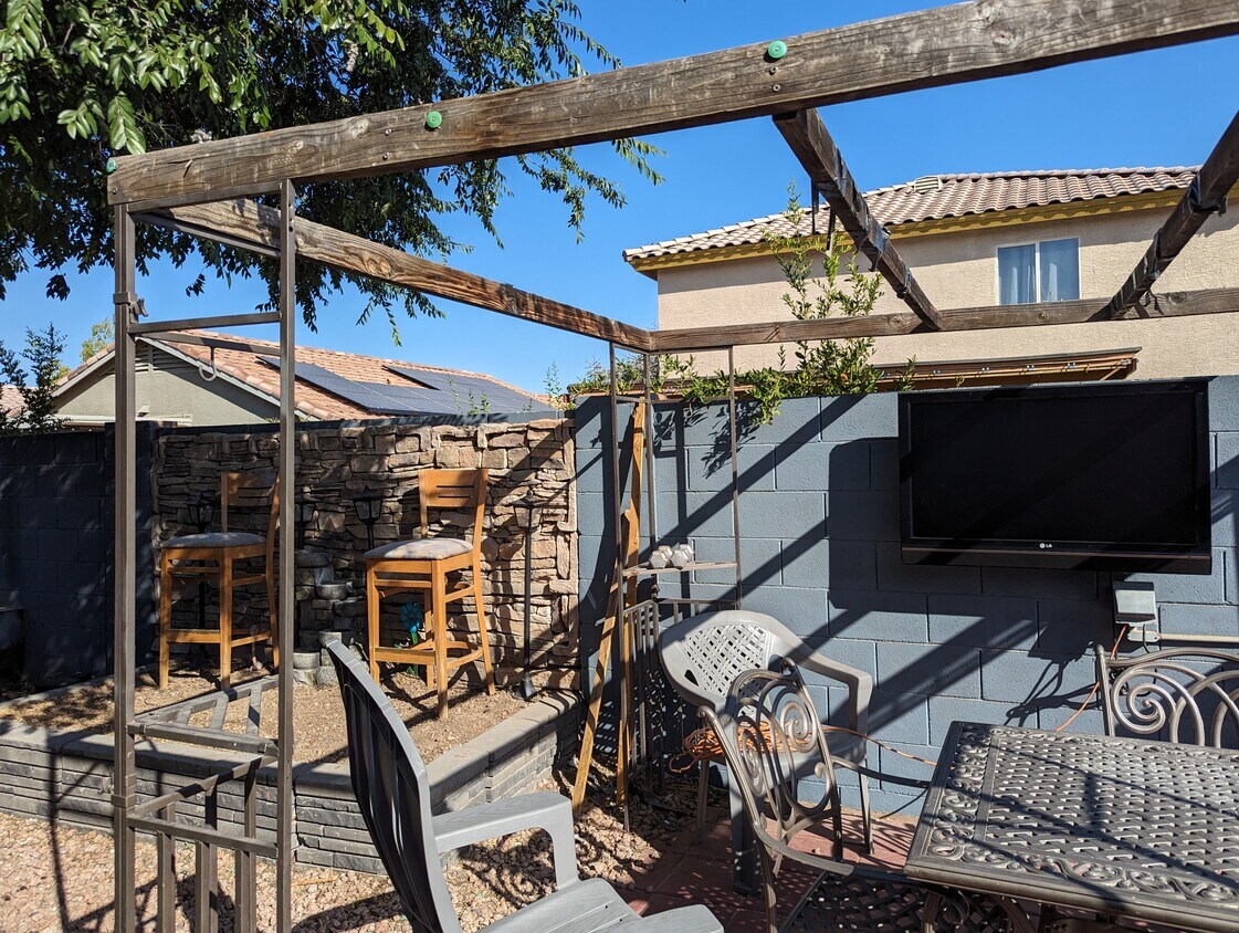 Backyard seating Area and TV. - 12037 W Scotts Dr