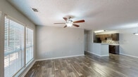Located at 1 Magnolia Cir in Jonesboro, GA, this single-floor, 2-bedroom, 2-bathroom home offers a well-designed layout with functional living spaces throughout. The open living room is a welcoming focal point, featuring durable wood-look flooring, a ceiling fan with light fixture, a textured ceiling, and large windows fitted with blinds that allow for ample natural light. The space flows seamlessly into the kitchen via a pass-through counter, making it ideal for everyday living and entertaining. The kitchen is well-appointed with dark espresso cabinetry, light stone countertops, a tile mosaic backsplash, black appliances including a range and refrigerator, and a stainless steel sink. A closet within the kitchen provides added storage convenience. Both bedrooms are carpeted and offer a quiet, comfortable retreat. The primary bedroom is generously sized and includes access to a walk-in closet with built-in shelving and rod. The bathrooms are finished with dark vanity cabinetry, stone-look countertops, a large mirror, and wood-look tile flooring. A dedicated hallway connects the bedrooms and bathrooms, providing a practical flow throughout the home. Two closets offer additional storage throughout the unit.