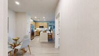 Located at 4741 Hoffner Avenue in Orlando, FL, this well-appointed 2-bedroom, 3-bathroom residence offers a thoughtfully designed single-floor layout with a clean, modern aesthetic and coastal-inspired color palette. Light wood-look flooring flows consistently throughout, unifying the open-concept living spaces.

The kitchen is a standout feature, showcasing flat-panel light wood cabinetry, white quartz countertops, a decorative tile backsplash, stainless steel appliances, and a central island with bar seating — ideal for both cooking and entertaining. The adjacent living room is bright and welcoming, with large windows that invite natural light and offer outdoor views, complemented by a ceiling fan overhead.

Both bedrooms are comfortably sized, with the primary bedroom featuring a soft accent wall, generous closet space, and an en-suite bathroom equipped with a glass-enclosed shower, built-in open shelving, and a wood-toned vanity with a white countertop. The second bedroom also benefits from natural light through large windows. Two dedicated closets provide additional storage throughout the home.

The bathrooms carry the same refined design language — light wood vanities, white countertops, and matte black fixtures — maintaining a cohesive and contemporary feel. Overall, the space exudes a bright, relaxed ambiance with modern detailing at every turn.