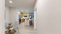 Located at 4745 Hoffner Ave in Orlando, FL, this well-designed two-bedroom, three-bathroom residence offers a thoughtfully planned single-floor layout with contemporary finishes throughout. Light wood-tone flooring flows seamlessly across all rooms, creating a cohesive and airy feel.

The kitchen is a standout feature, showcasing flat-panel light wood cabinetry that extends to the ceiling, white quartz countertops, stainless steel appliances including a French door refrigerator and range, a geometric tile backsplash, and a central island with bar seating — ideal for casual dining and entertaining.

The open living room is bathed in natural light from large windows that frame outdoor views, and is completed by a ceiling fan and direct access to a private exterior door. The primary bedroom offers a comfortable retreat with its own ensuite bathroom featuring a glass-enclosed shower, built-in open shelving, and warm wood vanity cabinetry. The second bedroom also benefits from generous natural light and outdoor views. Two dedicated closets provide ample storage throughout. Each of the three bathrooms maintains the home's consistent modern aesthetic with clean lines, light wood vanities, white countertops, and black fixture accents.