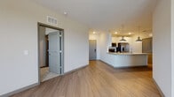 Located at 7950 Park Blvd N in Pinellas Park, Florida, this single-floor residence offers a thoughtfully designed open-concept layout with clean, contemporary finishes throughout. Light-toned wood-style flooring flows seamlessly across the main living areas, complemented by crisp white walls and recessed lighting that create a bright, welcoming ambiance.

The kitchen serves as a central highlight, featuring a generous granite-topped island with an undermount sink and stylish pendant lighting. White shaker cabinetry with sleek hardware lines the walls, paired with a subway tile backsplash and a full suite of stainless steel appliances, including a side-by-side refrigerator with ice and water dispenser, electric range, and built-in microwave. A dedicated laundry area with a full-size washer and dryer is conveniently accessible just off the kitchen.

The open living area is spacious and filled with natural light from large windows, offering an airy sense of scale. The bathroom is well-appointed with granite countertops, dual undermount sinks, white cabinetry, and a glass-enclosed walk-in shower with white tile surround. A walk-in closet with wire shelving and carpeted flooring provides ample storage. Gray-toned interior doors with panel detailing add a polished, cohesive design element throughout the residence.