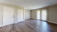 Located at 1040 Shive Ln in Bowling Green, Kentucky, this single-floor residence offers a well-organized layout designed for comfortable everyday living. The open living area is finished with durable hardwood-style flooring and features a ceiling fan with light fixture, neutral-toned walls, and a textured ceiling. A sliding glass door with vertical blinds allows natural light to fill the space, creating a bright and welcoming atmosphere. Adjacent to the living area, the kitchen is equipped with warm wood cabinetry, granite-style countertops, a stainless steel refrigerator, dishwasher, and a double-basin sink — providing both style and functionality. The bedrooms are carpeted for comfort and feature natural light through window blinds, with several rooms offering dedicated closet space including built-in shelving and hanging rods. The primary bathroom includes a vanity with granite-style countertops, warm wood cabinetry, hardwood-style flooring, and access to a closet. A second full bathroom features a shower/tub combination and matching wood-toned cabinetry. Throughout the home, consistent finishes such as white panel doors, clean baseboards, and neutral paint tones contribute to a cohesive and move-in ready aesthetic.