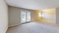 Located at 9007 Ten Mile Rd in Knoxville, Tennessee, this two-bedroom, one-bathroom home offers a practical and comfortable single-floor layout. The carpeted living room is a standout space, featuring French doors that open to a private balcony and an additional window that fills the room with natural light, creating a bright and open atmosphere. Neutral-toned walls and textured ceilings are consistent throughout the home, lending a clean and cohesive aesthetic. The kitchen is well-equipped with white cabinetry, dark granite-style countertops, wood-look flooring, and black appliances including a refrigerator, range, and dishwasher. It connects conveniently to a dedicated dining room, making mealtime functional and organized. A hallway leads to both bedrooms, each featuring plush carpet, neutral walls, and generous closet space — including a walk-in closet with dual hanging rods and a large bi-fold door closet. The bathroom features dark countertops and wood-look flooring, consistent with the kitchen's finishes. A utility room and four total closets throughout the home provide exceptional storage. The layout is efficient and well-organized, making this a comfortable and practical home in Knoxville.