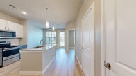 Located at 18313 FM 1093 in Richmond, TX, this single-story, one-bedroom, one-bathroom unit offers a thoughtfully designed layout with modern finishes throughout. Light-toned wood-look flooring flows consistently across the entire space, creating a clean, cohesive aesthetic.

The kitchen is a standout feature, equipped with stainless steel appliances — including a refrigerator, electric range, and over-the-range microwave — complemented by granite countertops, a white subway tile backsplash, and a two-tone cabinet design combining crisp white upper cabinets with slate-gray lower cabinets.

The bedroom is a comfortable, well-lit retreat featuring dual windows with white horizontal blinds that allow natural light to fill the room, along with a ceiling fan for added comfort. The room provides direct access to the bathroom and a dedicated closet, offering convenient and functional connectivity.

The bathroom continues the modern theme with gray cabinetry, granite countertops, a large vanity mirror, and updated fixtures. Light-toned flooring carries through here as well, maintaining visual consistency throughout the unit.

Neutral, warm-toned walls throughout the space contribute to an open, inviting atmosphere, while the efficient and well-organized floor plan ensures every square foot is purposefully utilized.