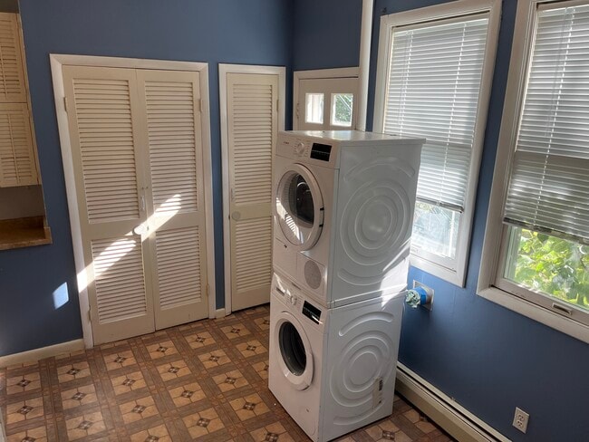 Den/Small Room with a washer/dryer and door to the patio. - 4836 Reservoir Rd NW