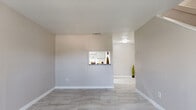 Located at 10555 Spice Ln in Houston, TX, this two-story, 1-bedroom, 2-bathroom home offers a thoughtfully laid-out floor plan spread across two levels. Light-toned marble-style tile flooring runs throughout, creating a clean and cohesive aesthetic.

The main floor features a welcoming entrance that opens to a combined living and dining area. The living room is bright and airy, benefiting from natural light through blinds-fitted windows. A pass-through window connects the living area to the compact kitchen, which is equipped with granite countertops and cabinetry. An adjacent pantry provides additional storage. A half-bath tucked neatly beneath the staircase completes the first floor, featuring a pedestal sink and tile flooring.

Carpeted stairs lead to the upper level, where the spacious primary bedroom awaits. This generously sized room features a fireplace, a ceiling fan, multiple windows offering outdoor views, and direct access to a full en-suite bathroom. The full bathroom is a standout feature, showcasing a tub/shower combination with floor-to-ceiling marble-style tile surround. Two closets provide ample storage on this level.

Textured ceilings throughout add a classic touch, while the neutral warm-beige walls create a versatile, move-in-ready canvas throughout the home.