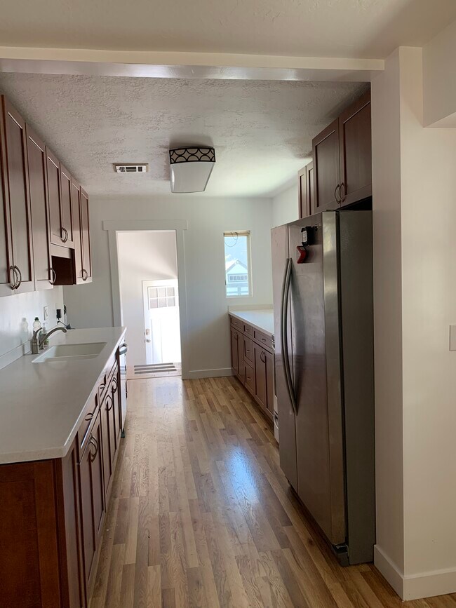 Long kitchen with lots of cabinets and counter space. Stainless steel appliances! - 544 Wilmington Ave