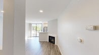 Located on Federal Avenue in the desirable West Los Angeles neighborhood of 90025, this thoughtfully designed studio offers a clean, modern aesthetic with an efficient single-floor layout. Light-toned hardwood-style flooring runs throughout the space, creating a cohesive and airy feel.

The open living area is bright and welcoming, bathed in natural light that pours in through a floor-to-ceiling sliding glass door. This door leads directly to a private balcony framed by lush, mature trees — offering a serene, green outlook that brings a touch of nature into the urban setting. Recessed lighting complements the natural light, and a fireplace adds a charming architectural focal point to the room. A half-wall partition suggests a defined kitchen area nearby.

The bathroom is well-appointed with a white vanity featuring brushed nickel hardware, a quartz countertop, a large dark-framed mirror, and a combination shower/tub — all finished with the same light hardwood-style flooring that ties the space together.

A dedicated closet provides practical storage. The overall palette of crisp white walls and neutral flooring lends the space a fresh, move-in-ready quality, making it an inviting and functional residence in a prime Los Angeles location.