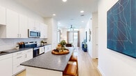 Located at 1609 W Chapman Dr in Sanger, TX, this single-floor residence offers a thoughtfully designed layout comprising one bedroom, one closet, a living room, and a fully equipped kitchen. Light wood flooring runs throughout, creating a cohesive and airy feel across all spaces.

The kitchen is outfitted with crisp white cabinetry, dark granite countertops, a white subway tile backsplash, and a full suite of stainless steel appliances including a refrigerator, dishwasher, microwave, and range. Ample upper and lower cabinet storage ensures excellent functionality.

The living room is bright and welcoming, benefiting from large floor-to-ceiling windows and transom windows above that flood the space with natural light and provide views of the surrounding neighborhood. A ceiling fan, recessed lighting, and light-toned walls contribute to the open, comfortable atmosphere.

The bedroom is a calm retreat, featuring dual windows with transom panes above for added natural light, recessed ceiling lights, and sufficient space for a full furniture arrangement. It connects to a well-organized walk-in closet with dual hanging rods, open shelving, and light wood flooring — offering practical and generous storage.

Overall, the space presents a clean, modern aesthetic with warm accents, making it a functional and inviting home in Sanger, TX.