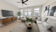Located in Norwood, OH 45212, this 3-floor, 4-bedroom, 2-bathroom home offers 1,290 square feet of thoughtfully designed living space. The main floor (560 sq ft) centers on an open-concept kitchen and living area with light hardwood flooring, recessed lighting, and ceiling fans. The kitchen features white shaker cabinets with matte black hardware, white quartz countertops, a large center island with a single-basin sink, and stainless steel appliances including a range, microwave, and refrigerator. A separate pantry door and white tile backsplash complete the space. The two bathrooms maintain a clean, modern aesthetic — one includes a sleek single-basin vanity with a wall mirror and high transom window, while the other features a glass-enclosed walk-in shower with built-in shelving and hardwood-style flooring throughout. The upper floor (530 sq ft) houses the bedrooms, including a 140 sq ft primary bedroom with plush carpet, ceiling fan, and multiple windows offering neighborhood views. Additional bedrooms are carpeted and well-lit with large windows and ceiling fans. The entry level (200 sq ft) provides access via one of three staircases connecting all floors. The home's consistent white palette and modern finishes create a bright, cohesive atmosphere throughout.