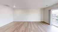 Located at 8000 Paradise Way in West Richland, WA, this 2-bedroom, 2-bathroom unit offers a well-designed single-floor layout with a clean, modern aesthetic throughout. Light wood-style flooring runs continuously across all living areas, complementing the bright white walls and creating a cohesive, airy feel.

The open-concept kitchen and living room anchor the unit, with the kitchen featuring dark navy cabinetry extending to the ceiling, white countertops, a tiled backsplash, and a full suite of stainless steel appliances including a refrigerator, range, and built-in microwave. The adjacent living area is generously sized and filled with natural light from a sliding glass door that opens to a private balcony overlooking the surrounding neighborhood and open skies.

Both bedrooms are comfortably scaled, with the primary bedroom offering a closet with sliding doors. The secondary bedroom includes a window with neighborhood views and ample natural light. Two full bathrooms each feature a tub/shower combination with brushed metal fixtures and clean white surrounds. Additional storage is provided through a dedicated utility room and closet. The unit presents a move-in ready, contemporary living environment suited for a variety of lifestyles.