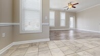 This well-designed 3-bedroom, 2-bathroom single-story home in Duncan, SC offers a thoughtfully laid-out floor plan with a clean, modern aesthetic throughout. The open-concept living and dining area is bathed in natural light from multiple large windows dressed with white blinds, and features a combination of durable tile and wood-look luxury vinyl plank flooring. A ceiling fan and crown molding add to the polished finish of the main living space.

The kitchen is equipped with rich dark-wood cabinetry, granite countertops, stainless steel appliances including a refrigerator, range, microwave, and dishwasher, as well as pendant lighting and tile flooring — ideal for both everyday cooking and entertaining.

The spacious primary bedroom offers generous proportions and connects to a well-appointed en-suite bathroom featuring dual dark-wood vanities with granite countertops, large-format tile flooring, and direct access to a walk-in closet outfitted with wire shelving. A second full bathroom mirrors the same refined finishes with a dual-sink vanity, granite countertops, and tile flooring.

The two additional bedrooms feature the same wood-look vinyl plank flooring and neutral wall tones, providing versatile spaces. Throughout the home, consistent warm-neutral paint tones, white trim, and quality finishes create a cohesive and inviting atmosphere.