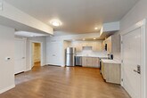 Located at 2507 Orogrande Lane in Caldwell, Idaho, this thoughtfully designed one-bedroom, one-bathroom unit offers a clean, modern aesthetic across a well-utilized single floor. The open-concept living area seamlessly integrates the living room, dining space, and kitchen, creating a connected and functional layout ideal for everyday living. The kitchen is a standout feature, showcasing light wood flat-front cabinetry, crisp white countertops, and a full suite of stainless steel appliances including a refrigerator, dishwasher, range, and microwave. Recessed lighting illuminates the kitchen area, complementing the warm hardwood-style flooring that runs throughout the unit. The bedroom is a calm, well-proportioned retreat featuring a ceiling fan, a natural light-filled window with blinds, and neutral wall tones. A dedicated closet provides generous storage. The bathroom is clean and practical, offering a tub/shower combination, a single vanity with wood cabinetry, and consistent hardwood-style flooring. Additional conveniences include an in-unit laundry area. The unit's neutral color palette, modern finishes, and efficient floor plan make it a practical and attractive living space.