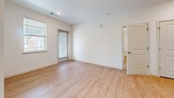 Located at 8775 Clay St in Westminster, Colorado, this single-floor, 3-bedroom, 2-bathroom residence presents a clean and contemporary design throughout. Light wood-style flooring flows seamlessly across every room, creating a warm and cohesive aesthetic.

The kitchen is efficiently designed with light wood cabinetry, white subway tile backsplash, white countertops, and a full suite of stainless steel appliances, including a refrigerator, dishwasher, microwave, and range. Recessed lighting enhances the functional workspace.

The living area features large windows fitted with blinds, allowing ample natural light, along with sliding glass door access. The three bedrooms are bright and well-proportioned, each featuring light wood flooring, ceiling fans, and windows that invite natural light. The primary bedroom offers generous closet space with sliding double doors. Additional bedrooms also include sliding closet doors for efficient storage.

The two bathrooms are finished in a modern style. One features a soaking tub with a tiled surround and brushed bronze fixtures, while the other includes a wood-toned vanity with a white countertop, a large mirror, and brushed nickel hardware. Both bathrooms continue the light wood flooring found throughout the home, maintaining a consistent and polished look.