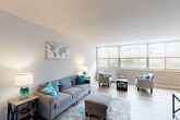Located at 7911 Indian Head Hwy in Oxon Hill, MD, this well-appointed one-bedroom, one-bathroom residence offers a thoughtfully designed layout across a single floor. Light wood-style flooring flows throughout, lending a clean, cohesive feel to the entire space.

The combined living and dining area is bright and inviting, anchored by a wall of large windows that flood the room with natural light and offer pleasant outdoor views of surrounding greenery. The open layout provides generous space for both relaxing and entertaining.

The kitchen features warm honey-toned cabinetry, granite-look countertops, a gas range, and full-size refrigerator. A passthrough view into the dining area enhances the sense of connectivity throughout the home.

The bedroom is a comfortable retreat, also benefiting from oversized windows with outdoor views. It offers ample room for a full furniture arrangement and includes closet storage. In total, four closets are distributed throughout the unit, providing excellent storage capacity.

The bathroom is clean and well-finished, featuring a full tub-shower combination with white tile surround, a vanity with white cabinetry, and a large mirror. The neutral gray and white palette gives it a crisp, modern feel.

Overall, this residence combines functional design with bright, airy interiors in a convenient Oxon Hill location.