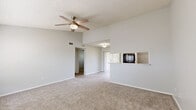 Located at 6101 Westgate Dr in Orlando, FL, this single-floor, one-bedroom, one-bathroom residence offers a well-organized and functional layout. The open-concept living room greets you with vaulted ceilings, soft carpet flooring, and a ceiling fan overhead. Large windows and a sliding glass door with vertical blinds allow natural light to fill the space, while a pass-through window connects seamlessly to the kitchen. The kitchen features white cabinetry, light stone countertops, light wood-style LVP flooring, and black appliances including a range, dishwasher, and refrigerator. The bedroom is a comfortable, carpeted retreat with a ceiling fan and a window that brings in natural light. A dedicated closet provides convenient storage. The bathroom is finished with a white vanity, stone-look countertop, LVP flooring, and a tub-shower combination. A dedicated laundry room houses full-size side-by-side washer and dryer units alongside wire shelving and a water heater. Neutral gray tones, textured ceilings, and consistent finishes throughout create a clean, cohesive ambiance well-suited for comfortable everyday living.