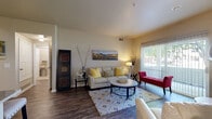 Located at 2801 Nelson Rd in Longmont, CO, this one-bedroom, one-bathroom residence offers a well-designed single-floor layout that maximizes every square foot. Rich hardwood-style flooring flows throughout the main living areas, anchoring a bright and inviting living room that features a tiled corner fireplace, large sliding glass doors, and abundant natural light. The sliding doors open to a private balcony, providing a seamless indoor-outdoor connection. The kitchen is thoughtfully appointed with white cabinetry, granite countertops, a breakfast bar peninsula with seating, stainless steel appliances including a range, microwave, and refrigerator, and track lighting overhead. Adjacent to the kitchen, a dedicated dining area offers comfortable separation from the living space. The bedroom is carpeted for warmth and comfort, fitted with a ceiling fan and generous natural light from a window with blinds. A dedicated closet provides ample storage. The bathroom features a well-lit vanity with under-sink cabinetry and a large mirror. Additional practical spaces include a hallway, pantry, utility room, and an in-unit laundry area, making this residence a comprehensively equipped home in the heart of Longmont.