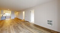 Located at 700 Lincoln Village Circle in Larkspur, CA, this single-floor, one-bedroom, one-bathroom residence offers a clean and modern aesthetic throughout. Light wood-tone flooring runs through the main living areas, creating a bright and cohesive feel, while neutral white walls maximize the sense of openness.

The kitchen is thoughtfully designed with white upper cabinetry, light gray lower cabinets, white quartz countertops, and a classic subway tile backsplash. Stainless steel appliances — including a range, over-the-range microwave, and refrigerator — complete the space, which opens toward the living area, allowing for an easy flow between cooking and entertaining.

The living room is spacious and airy, with large sliding glass doors that invite natural light and provide outdoor views. The open layout connects seamlessly to the kitchen, forming a practical and inviting combined living space.

The bedroom features plush carpeting, a ceiling fan with light fixture, a mirrored sliding closet, and a window overlooking the outdoors, filling the room with natural light and views of surrounding greenery.

The bathroom is clean and functional, featuring a full tub-shower combination with white subway tile surround, chrome fixtures, and wood-look flooring. The overall design of the residence is consistent and modern, with an emphasis on light, comfort, and functionality.