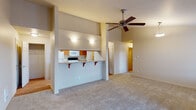 Located at 13250 SE 162nd Ave in Happy Valley, Oregon, this single-floor residence offers a well-designed layout with a thoughtful blend of comfort and functionality. The open-concept living area is a standout feature, boasting soaring vaulted ceilings and a ceiling fan that enhance the sense of spaciousness. A pendant light fixture adds a decorative touch, while neutral-toned carpet throughout the living space creates a warm, inviting atmosphere.

The kitchen is efficiently designed in a galley style, featuring warm wood cabinetry, granite-style countertops, and a full suite of appliances including a refrigerator, electric range, microwave, and dishwasher. Light hardwood flooring runs throughout the kitchen, adding a clean contrast to the carpeted areas. A pass-through counter with bar seating connects the kitchen to the living area, making it ideal for casual dining and interaction.

The bedroom offers plush carpeting, a ceiling fan, and a window that brings in natural light and outdoor views of the surrounding neighborhood. Sliding glass doors lead to a private balcony, extending the living space outdoors. The bathroom features a single-sink vanity with warm wood cabinetry, light countertops, and a tub-shower combination. A walk-in closet provides generous storage. This residence delivers a comfortable, practical living environment in a desirable Happy Valley location.