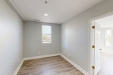 Located in Washington, DC's vibrant Columbia Heights neighborhood, this two-bedroom, one-bathroom residence offers a thoughtfully designed single-level layout with clean, modern finishes throughout. Light hardwood flooring flows seamlessly from the welcoming entrance hallway through every room, creating a cohesive and airy feel.

The combined dining and living area provides a flexible, open space ideal for both relaxing and entertaining. The kitchen is well-appointed with white cabinetry, bright white countertops, stainless steel appliances including a refrigerator, electric range, microwave, and dishwasher, plus a window above the sink that fills the space with natural light.

The spacious primary bedroom features a trio of tall, narrow windows that invite abundant natural light and offer treetop views, creating a serene retreat. The second bedroom is equally bright with its own window and easy access to a closet. Both bedrooms are finished in neutral tones that complement the light flooring. The bathroom includes a compact vanity with mirror and brushed nickel fixtures. Two closets provide convenient storage throughout the unit. The overall design palette of soft gray walls and warm wood-tone flooring lends the entire space a fresh, modern ambiance.