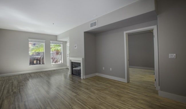 Spacious living room features a fireplace and access to private patio - The Palazzo at Park La Brea