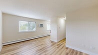 Located at 17 W Vine St in Pottstown, PA, this one-bedroom, one-bathroom unit offers a well-designed layout across a single floor. The open living area greets you with light hardwood-style flooring, neutral cream-toned walls, and multiple windows fitted with blinds that allow generous natural light to fill the space. Baseboard heating and a wall-mounted AC unit provide year-round climate control throughout the main living area.

The kitchen is a standout feature, outfitted with crisp white shaker-style cabinetry, dark countertops, and a full suite of stainless steel appliances including a range, over-the-range microwave, and refrigerator. A window above the counter adds additional natural light to the cooking space.

The generously sized bedroom is carpeted for comfort and includes a built-in sliding-door closet, a window with outdoor views, and easy access to the hallway. The bathroom is finished with clean white subway-style tile walls, light tile flooring, and a white vanity with brushed nickel hardware, creating a bright and functional space.

A hallway connects the rooms efficiently, and a dedicated closet provides additional storage. The unit's clean, neutral palette and updated finishes make it a practical and comfortable residence in the heart of Pottstown.